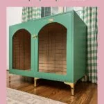 green and brass DIY wood dog crate that looks like furniture on display in bedroom