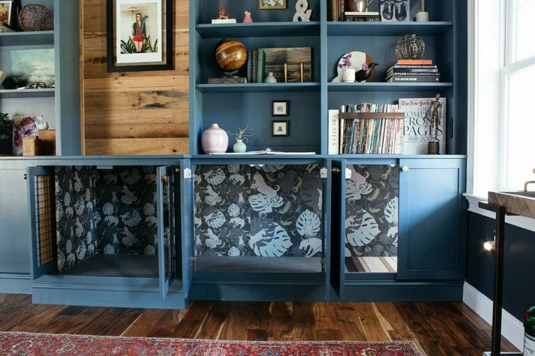 DIY dog crate built into wall of bookshelves and cabinets