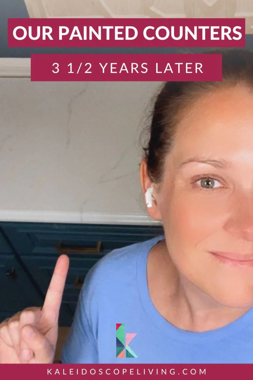 photo of a woman pointing at kitchen countertop with text overlay that reads "our painted counters 3 1/2 years later"