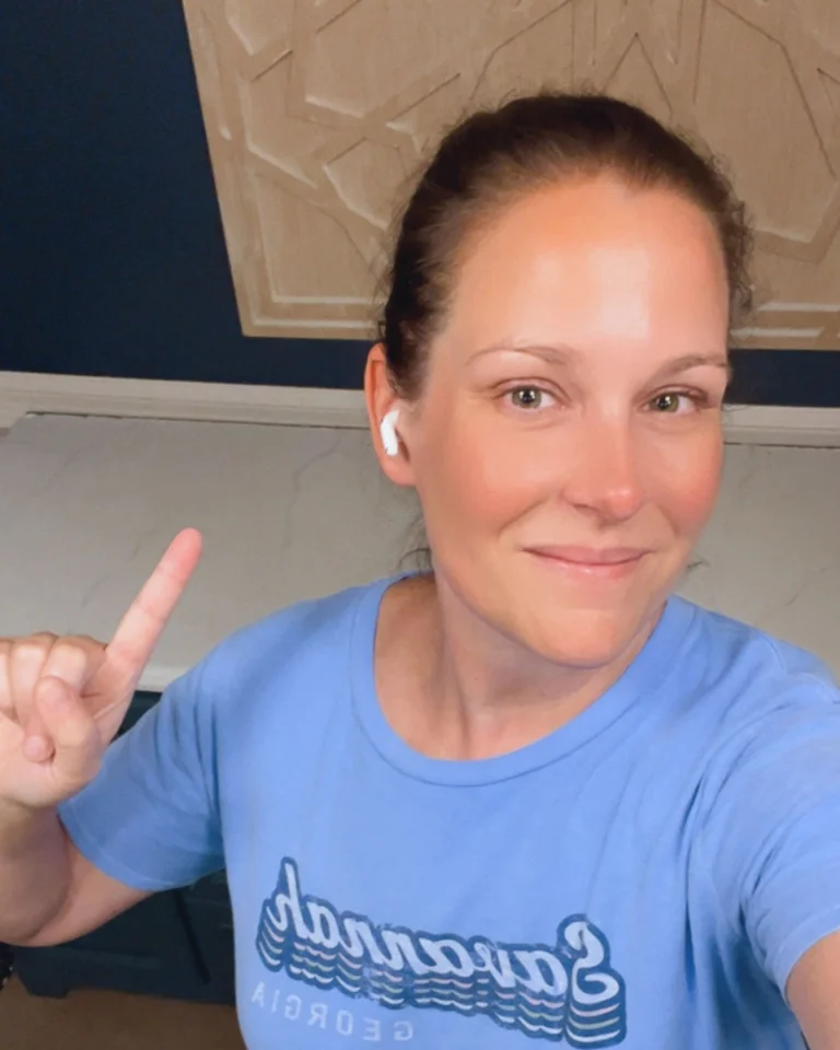 photo of woman pointing to painted kitchen counters over her shoulder