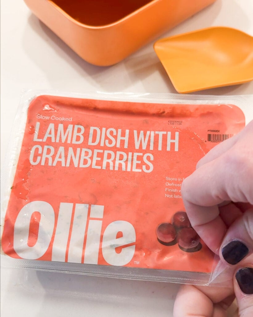 woman's hands opening package of Ollie fresh dog food